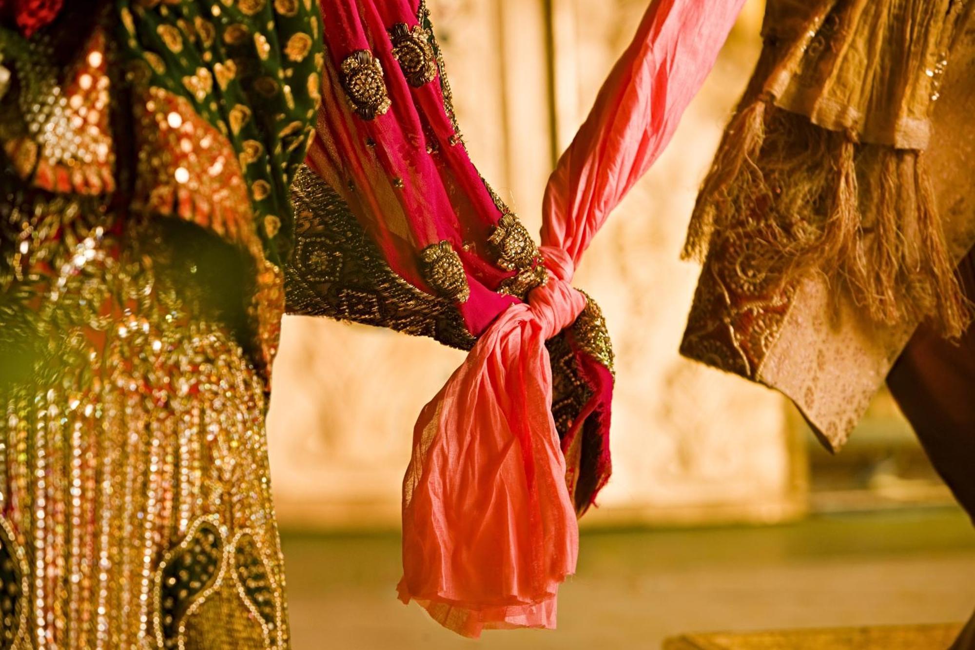 JW Marriott Hotel New Delhi Aerocity Kültér fotó The bride and groom hold hands during the wedding ceremony.